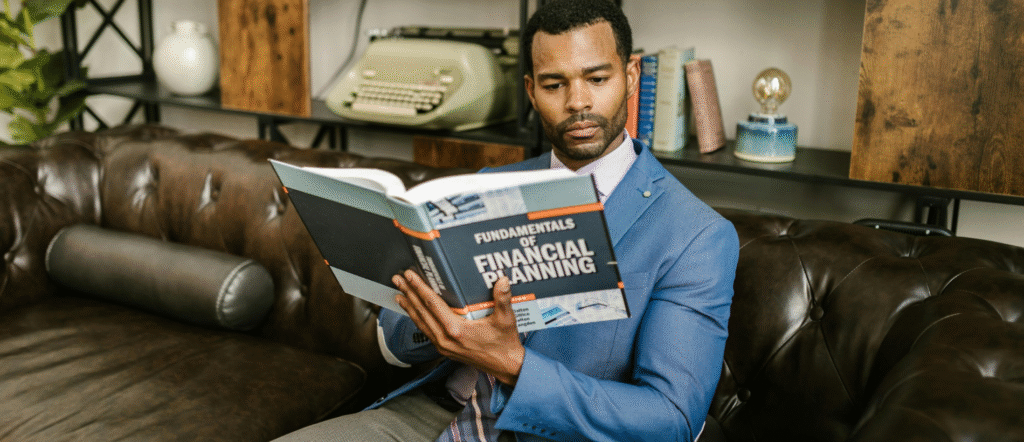 Small business owner in a bright workshop implementing circular economy practices in 2025, smiling while upcycling wooden furniture scraps into modern designs, surrounded by reusable materials and eco-friendly tools.