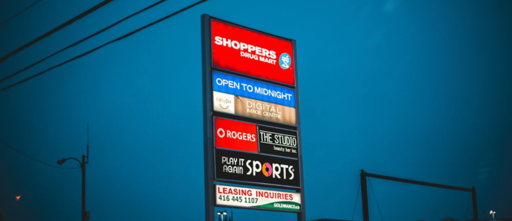 Business professional celebrating Google and Facebook ad approval success on laptop screen in 2025